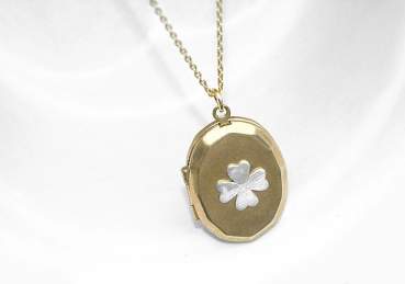 Four leaf clover locket necklace. Silver clover on vintage pendant
